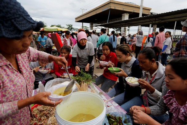 The Wider Image: Cambodian shoe maker has little time for politics