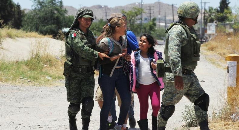 Mexican National Guard soldiers detain Central American migrants trying to cross the Rio Bravo - also known as the Rio Grande - into the United States at Ciudad Juarez