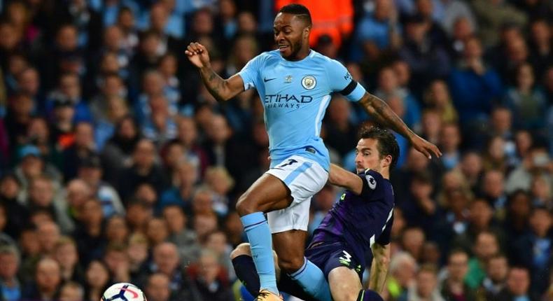 Manchester City's Raheem Sterling (L) fights for the ball with Everton's Leighton Baines during their English Premier League match, at the Etihad Stadium in Manchester, on August 21, 2017