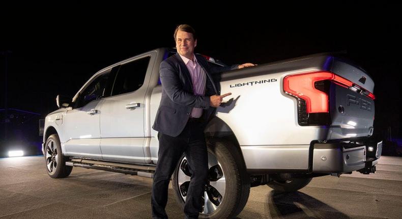 Ford CEO Jim Farley poses with an F-150 Lightning pickup truck.Bill Pugliano/Getty Images