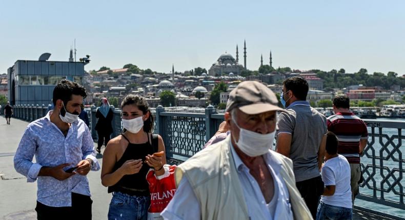 People wear protective face masks to curb the spread of the novel coronavirus (COVID-19) in Istanbul on July 1, 2020 -- concerns are growing in the country as the daily infection toll increases