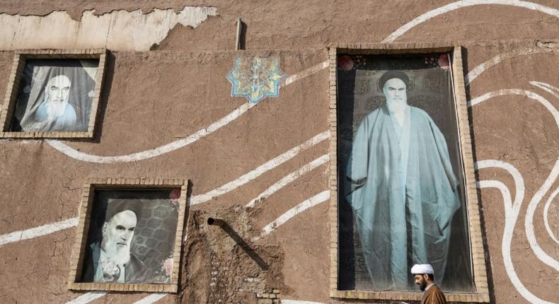 A Muslim Shiite cleric walks past the house of the late founder of the Islamic Republic, Ayatollah Ruhollah Khomeini, in the holy city of Qom