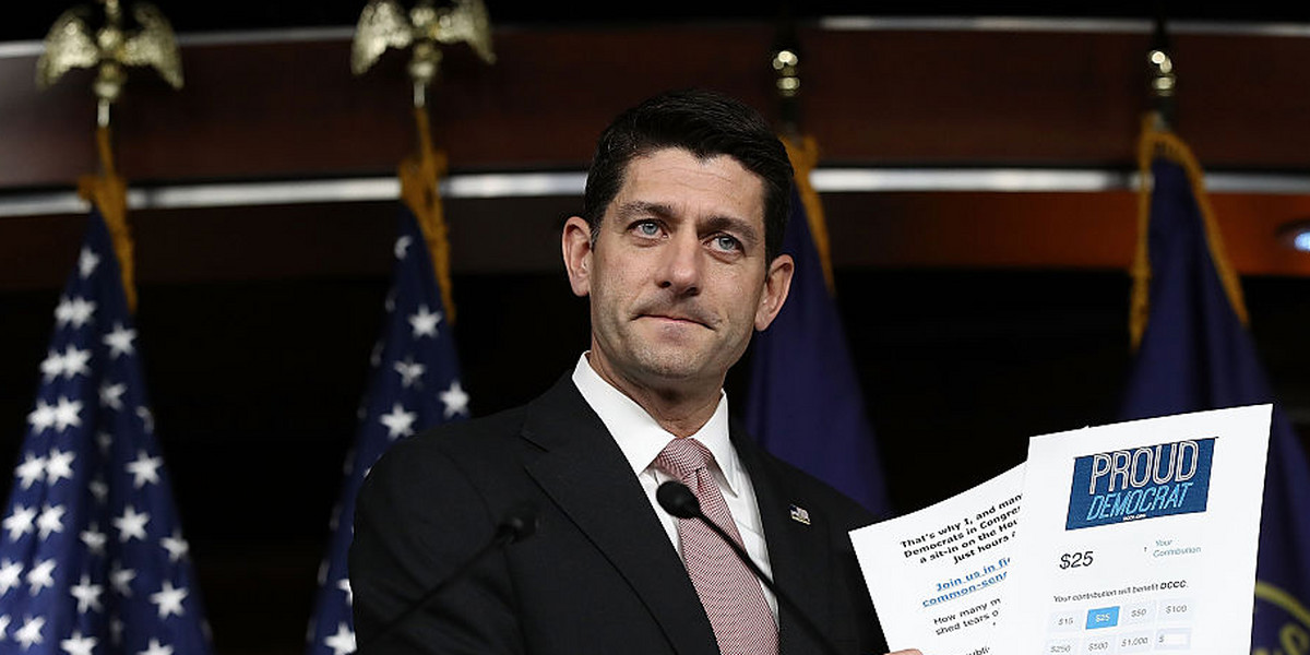 Paul Ryan holds up copies of Democratic fundraising emails during a press conference in Washington, D.C.