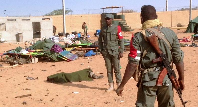 The body of a dead soldier is covered with a blanket after a suicide bomb attack ripped through a camp of former rebels and pro-government militia in northern Mali on January 18, 2017