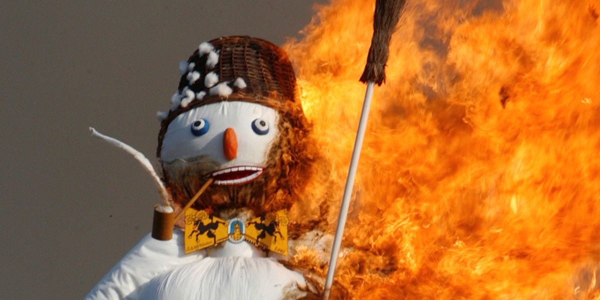 The Boeoegg, a snowman made of wadding and filled with firecrackers, burns atop a bonfire