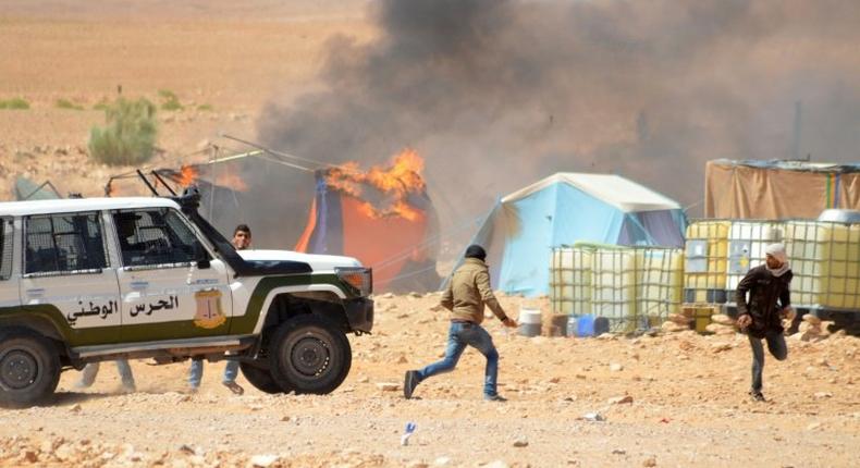 Tunisian protesters comfront security forces outside the El Kamour oil and gas pumping station, in the southern state of Tataouine, on May 22, 2017