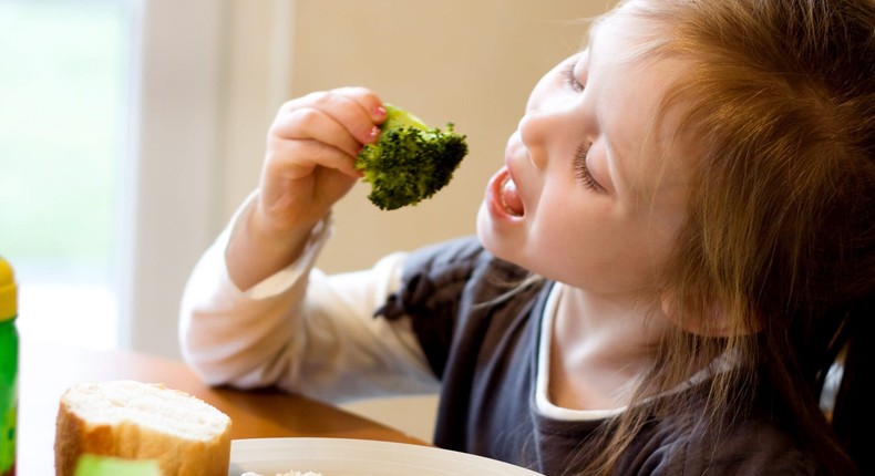 If your child sees you eat broccoli, they are more likely to try it themselves.Kelly Sillaste/Getty Images