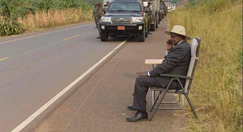 Ugandan president, Yoweri Museveni, making a phone call on the road side