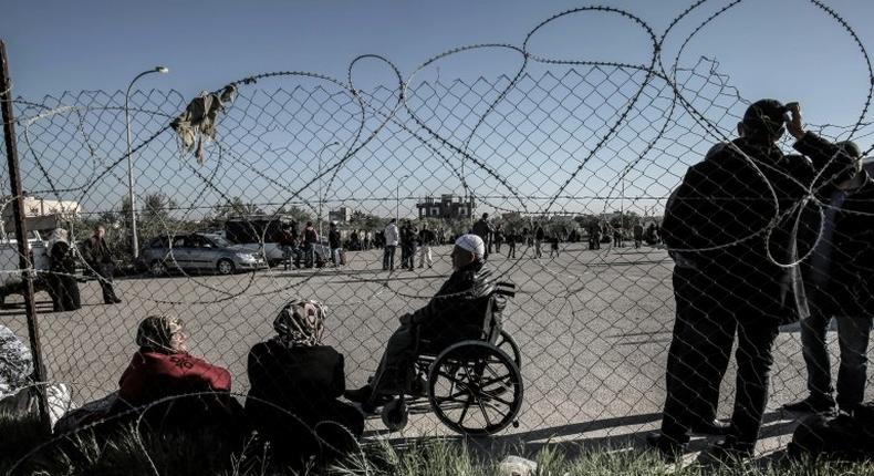 Palestinians wait for travel permits to cross into Egypt through the Rafah border crossing in March 2017