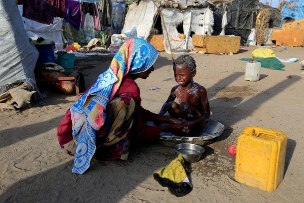 The Wider Image: Displaced Yemeni family sift through garbage for food