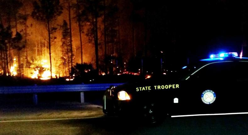 In this photo provided by the Florida Highway Patrol, flames burn near Interstate 75 in Collier County, Florida on March 8, 2017.