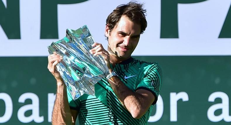 Roger Federer of Switzerland lifts the trophy following his victory over compatriot Stan Wawrinka in the ATP Indian Wells Masters final match, in California, on March 19, 2017