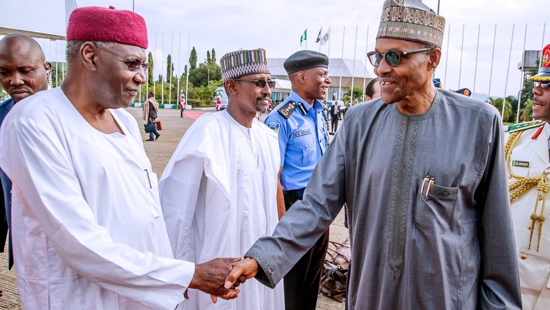 President Muhammadu Buhari (right) shakes hands with his Chief of Staff, Abba Kyari (left) [Presidency]