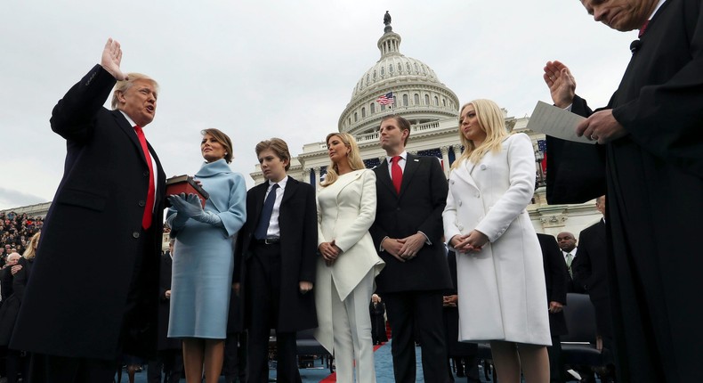 In this January 27, 2017, photo President Donald Trump takes the oath of office from Chief Justice John Roberts, as his wife, Melania Trump, holds the Bible.