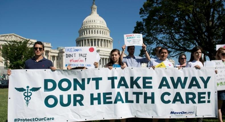 US protesters demonstrate against the Republicans' healthcare bill as they stage a rally outside the US Capitol in Washington, DC