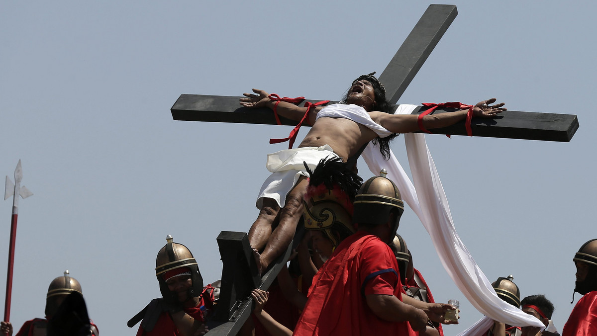 PHILIPPINES HOLY WEEK (Penitent is nailed to a wooden cross during the re-enactment of the crucifixion of Jesus Christ on Good Friday)