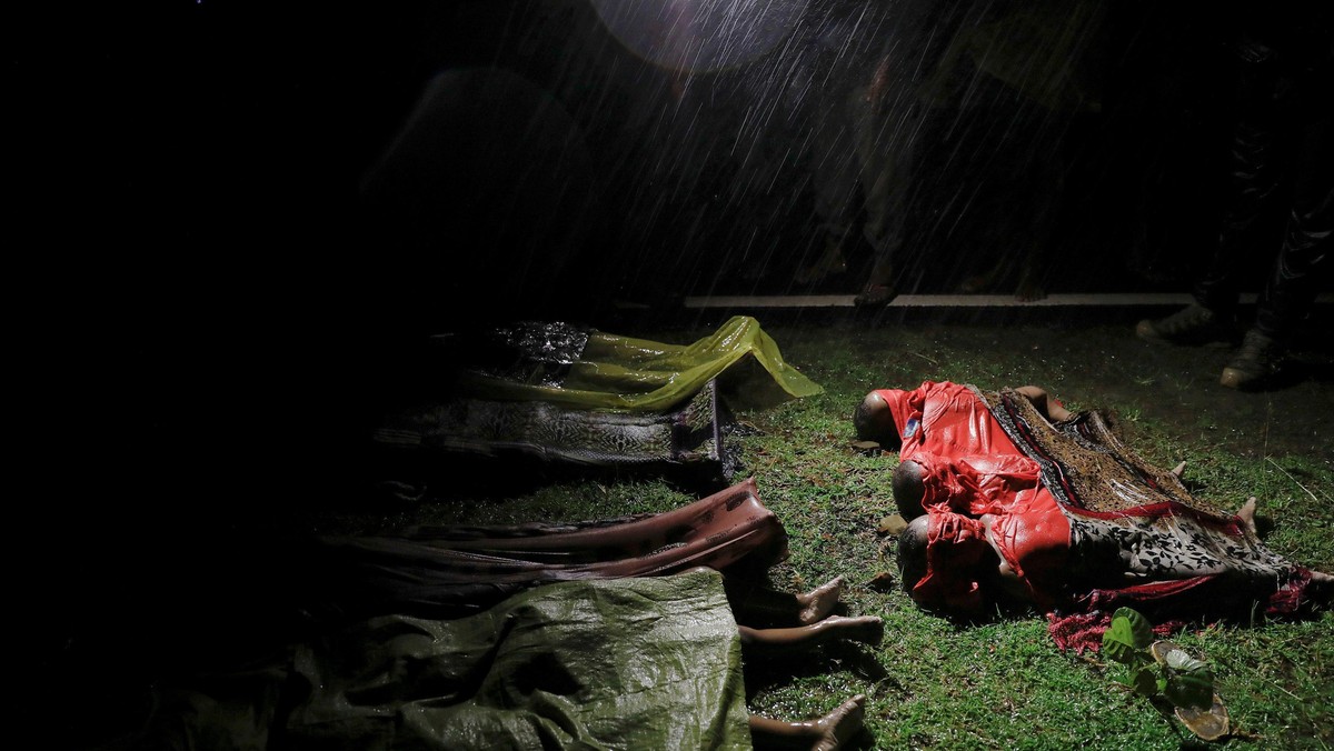 Bodies of children and other Rohingya refugees are covered after their boat with passengers fleeing from Myanmar capsized off the Inani beach near Cox's Bazar