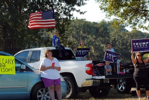 Supporters of U.S. Republican presidential nominee Donald Trump wait outside a campaign rally with U