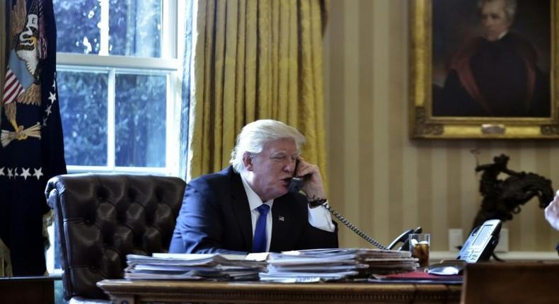 US President Donald Trump speaks on the phone with Russia's President Vladimir Putin from the Oval Office of the White House on January 28, 2017