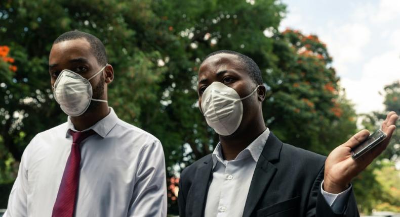 Zimbabwe Hospital Doctors Association president Tawanda Zvakada (R) and treasurer Tapiwa Mungofa speak to press at the Parirenyatwa Hospital in Harare, where they vowed to boycott work unless the government provides protective gear for  COVID-19