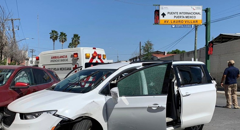 A member of the Mexican security forces stands next to a white minivan with North Carolina plates and several bullet holes, at the crime scene where gunmen kidnapped four U.S. citizens who crossed into Mexico from Texas, Friday, March 3, 2023.AP