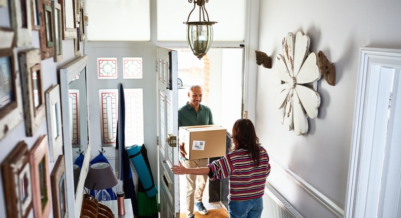 man delivering package to woman's home