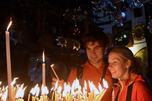 Christians Light Candles In Church Of Nativity In Bethlehem