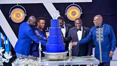 dfcu Bank management, and Guest of honor cutting cake during dfcu bank's 60 year anniverssary celebrations at Mestil Hotel