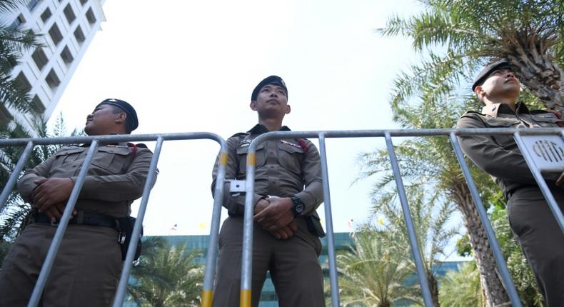 Policemen stand guard outside the Constitutional Court in Bangkok on Thursday ahead of a court ruling on the Thai Raksa Chart party