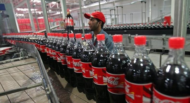 A worker checks bottles of Coca-Cola in Kabul September 10, 2006. 
