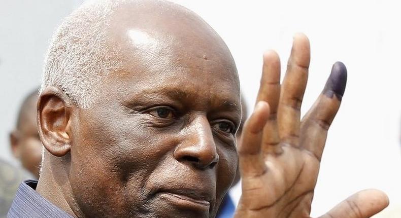 Angola's President Jose Eduardo dos Santos shows off his inked finger to photographers after casting his vote during national elections in the capital Luanda, August 31, 2012. REUTERS/Siphiwe Sibeko