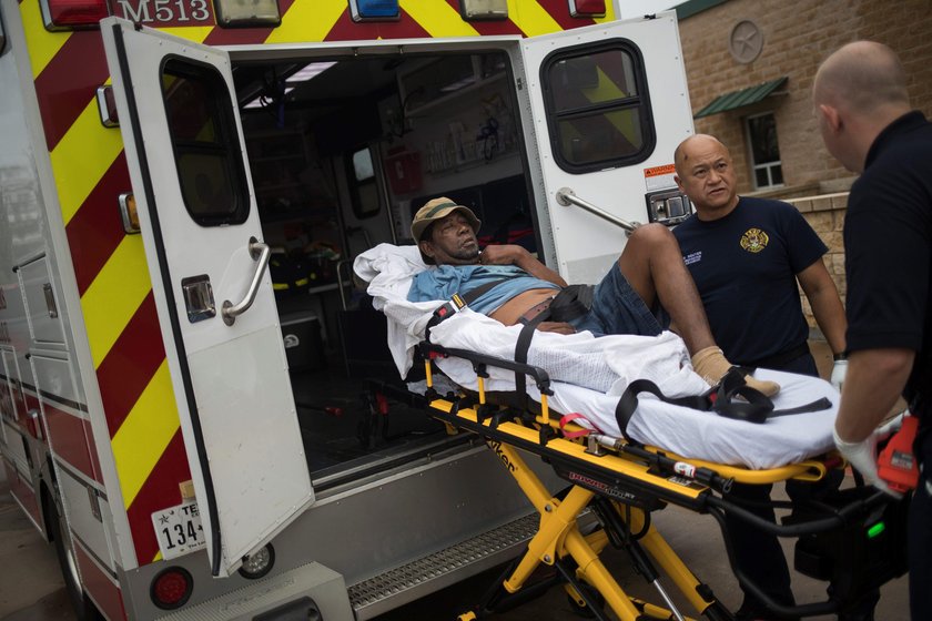 A man, who lost his home to Hurricane Harvey, is loaded into the back of an ambulance in Rockport, T