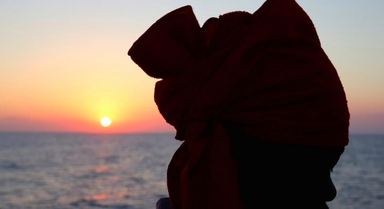 A migrant looks on from Vos Hestia ship after being rescued by Save the Children NGO crew in the Mediterranean sea off Libya coast, June 19, 2017.