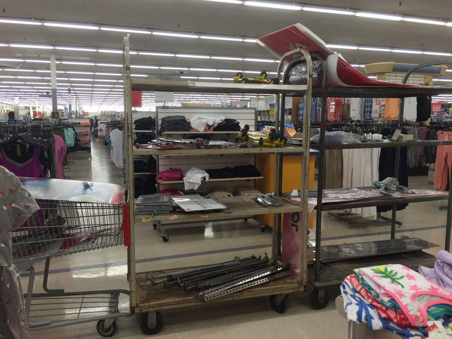 Abandoned shelves and carts cluttered this Kmart store's aisle.