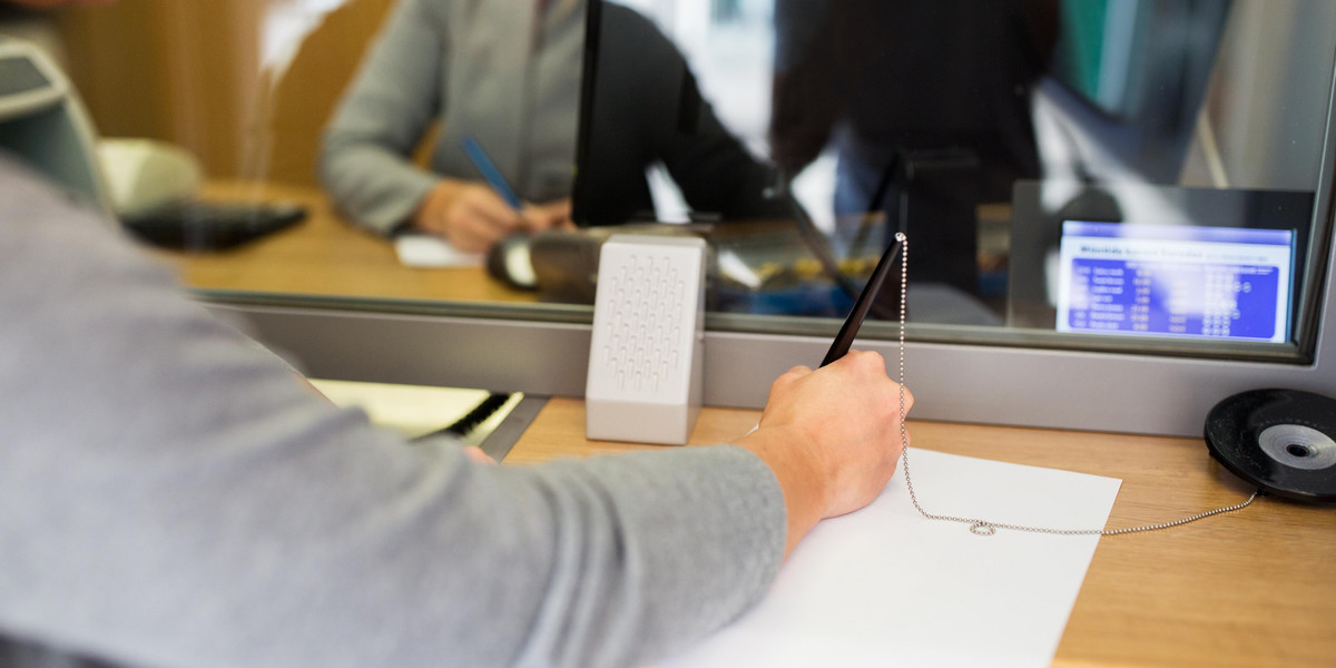 customer writing application at bank office