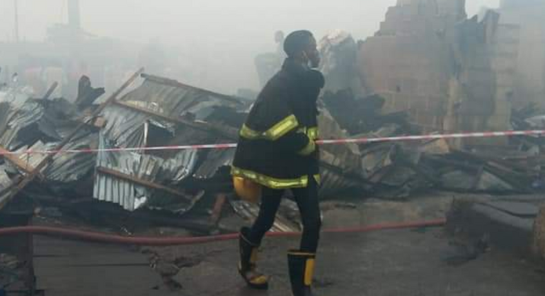 A Lagos State firefighter at scene of the incident [Punch]