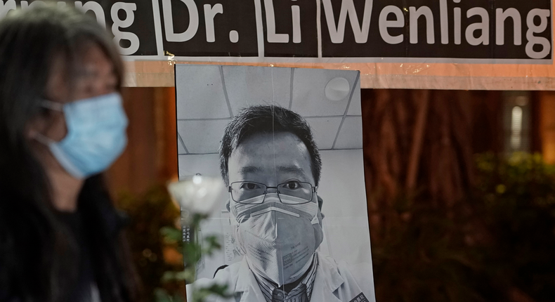 Pro-democracy activist Leung Kwok-hung, wearing a mask, attends a vigil for Chinese doctor Li Wenliang, in Hong Kong, Friday, Feb. 7, 2020. The death of a young doctor who was reprimanded for warning about China's new virus triggered an outpouring Friday of praise for him and fury that communist authorities put politics above public safety. (AP Photo/Kin Cheung)