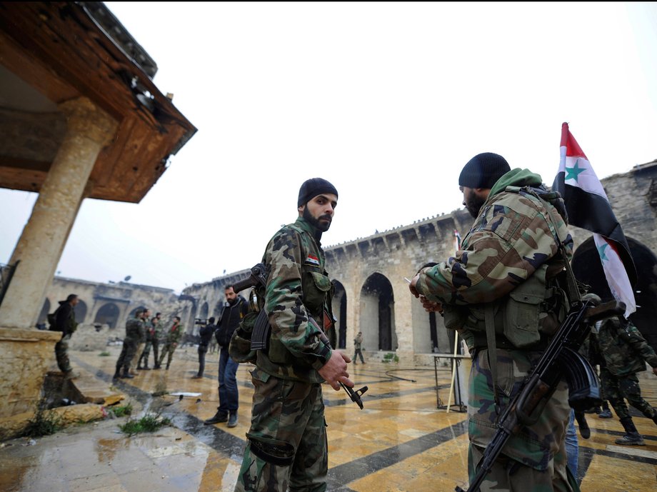 Forces loyal to Syria's President Bashar al-Assad stand inside the Umayyad mosque, in the government-controlled area of Aleppo, during a media tour, Syria December 13, 2016.