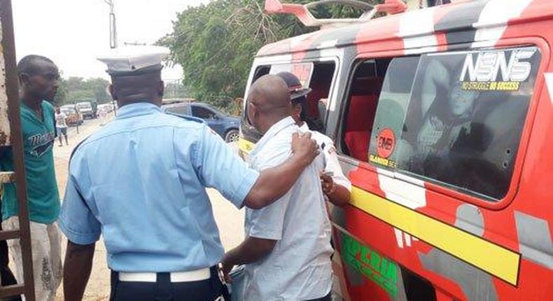 File image of a traffic police officer arresting a matatu operator