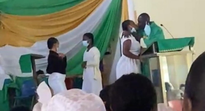 Anglican Priest kissing students