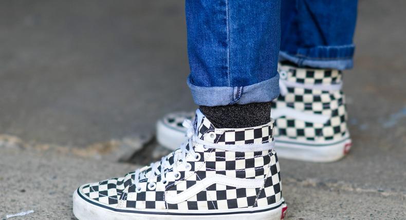 A person wears checkerboard Vans at New York Fashion Week on February 12, 2022.Edward Berthelot/Getty Images