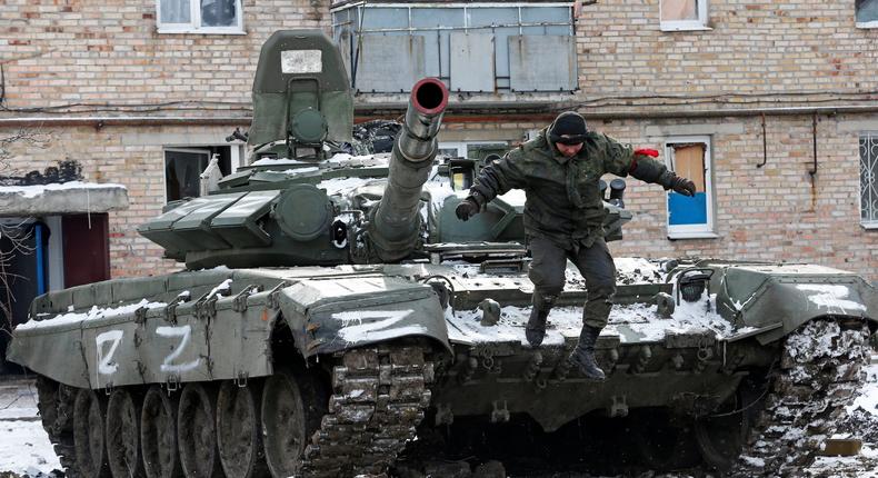 A member of pro-Russian forces jumps off a tank in the separatist-controlled town of Volnovakha in Ukraine's Donetsk region, March 11, 2022.