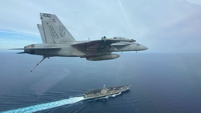 An F/A-18F Super Hornet flies past the aircraft carrier USS Harry S. Truman in November.US Navy courtesy photo by Lt. Lily Moorhead