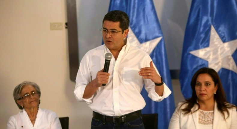 Honduran President Juan Orlando Hernandez (C) with mother Elvira Alvarado (L) and wife Ana Garcia announces that he will run for re-election in Tegucigalpa on November 9, 2016