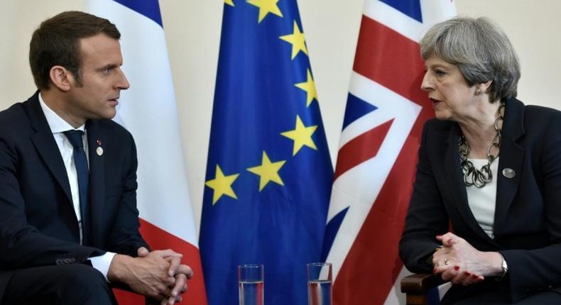 Britain's Prime Minister Theresa May (right) and French President Emmanuel Macron meet at the G7 summit in Taormina, Italy, on May 26, 2017