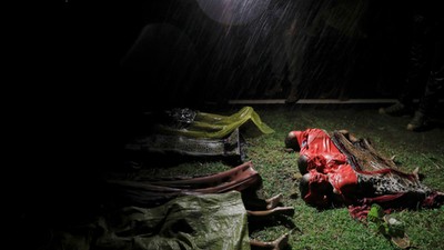 Bodies of children and other Rohingya refugees are covered after their boat with passengers fleeing from Myanmar capsized off the Inani beach near Cox's Bazar