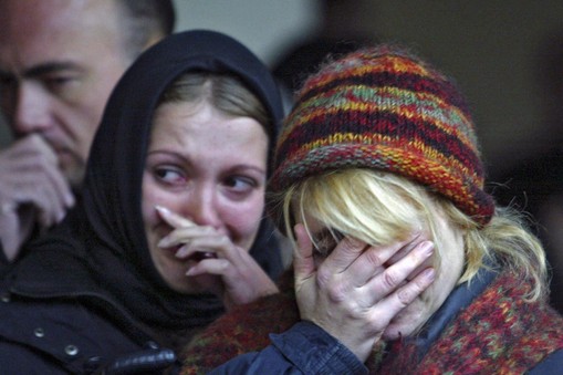 Women mourn during commemoration ceremony at the Dubrovka Theatre in Moscow