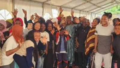 Amb. Kabiru Musa, Charge D’affaires en titre of the Nigerian Mission to Libya  flanked by some of the evacuees before departing Mitiga International Airport Tripoli on Tuesday. [NAN]