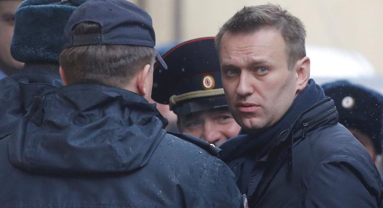 Russian opposition leader Alexei Navalny is escorted upon his arrival for a hearing after being detained at the protest against corruption and demanding the resignation of Prime Minister Dmitry Medvedev, at the Tverskoi court in Moscow, Russia March 27, 2017.