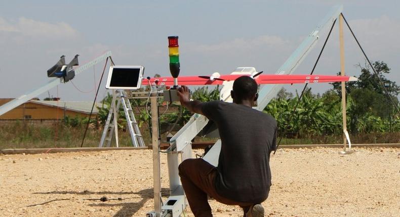 A technician of California-based robotics company Zipline launches a drone in Muhanga, west of the capital Kigali on October 12, 2016